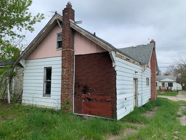 view of side of property with a chimney and board and batten siding