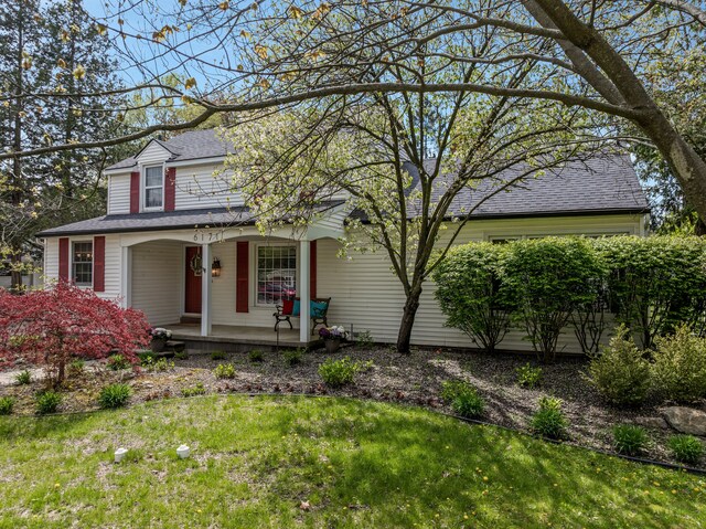 6171 S Main St, Clarkston, MI 48346 - view of front of home featuring covered porch, a front lawn, and roof with shingles