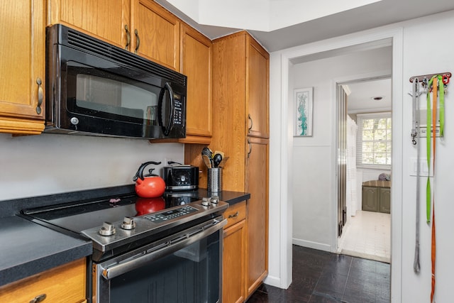6171 S Main St, Clarkston, MI 48346 - kitchen featuring black microwave, stainless steel electric range oven, brown cabinets, and dark countertops