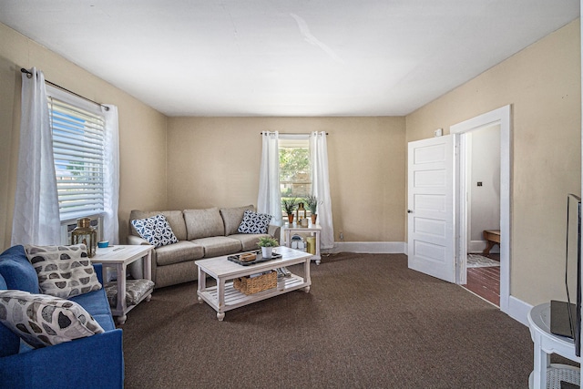 carpeted living area featuring baseboards