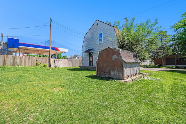 view of side of property featuring a gambrel roof, a storage shed, and an outdoor structure
