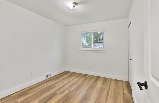 spare room with light wood-style flooring and baseboards