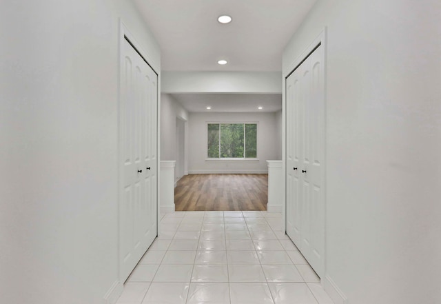 hall with recessed lighting, wood finished floors, and baseboards