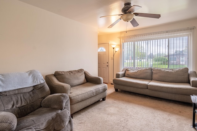 living area with light carpet and a ceiling fan