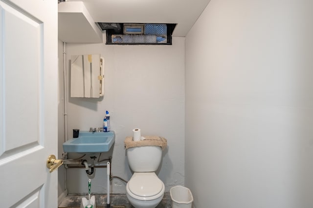 half bath featuring toilet and a sink