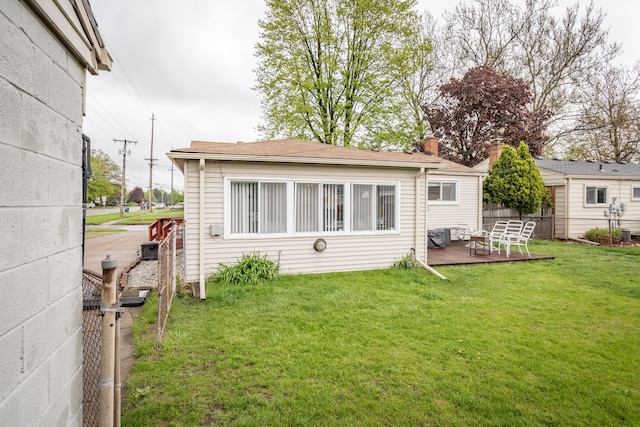 rear view of property featuring a wooden deck