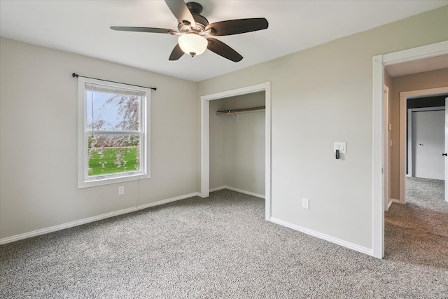 unfurnished bedroom featuring carpet flooring, a closet, baseboards, and a ceiling fan