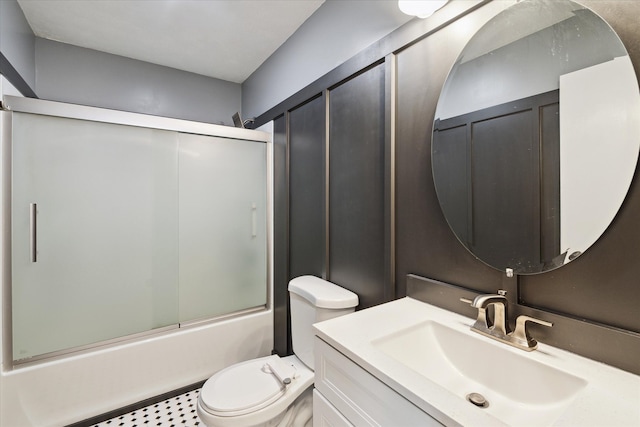 full bath with toilet, bath / shower combo with glass door, and vanity