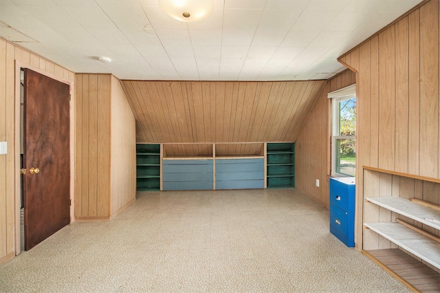 additional living space featuring wooden walls