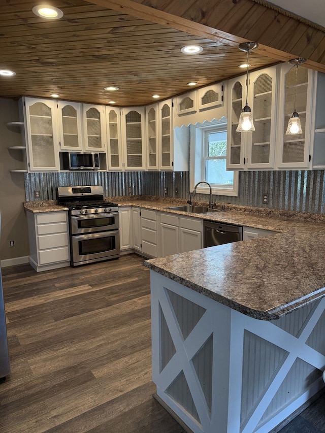 4212 4th St, Brown City, MI 48416 - kitchen with a sink, white cabinetry, a peninsula, stainless steel appliances, and tasteful backsplash