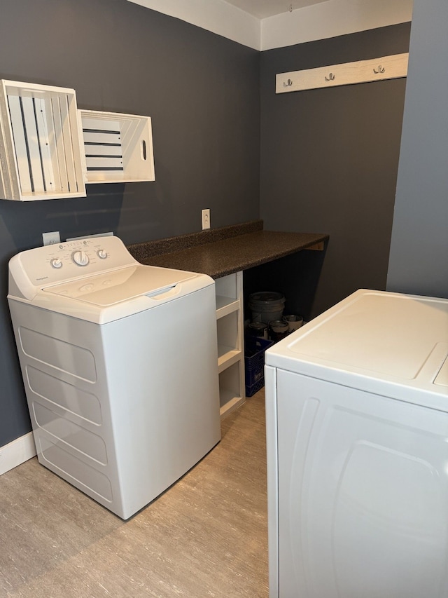 4212 4th St, Brown City, MI 48416 - washroom featuring separate washer and dryer, laundry area, light wood-type flooring, and baseboards