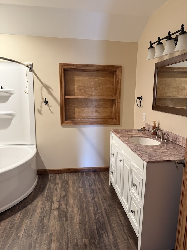 4212 4th St, Brown City, MI 48416 - bathroom featuring baseboards, vaulted ceiling, vanity, and wood finished floors
