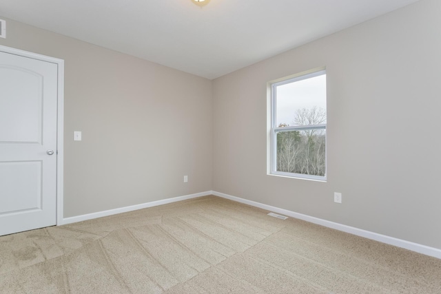 spare room featuring visible vents, baseboards, and carpet floors