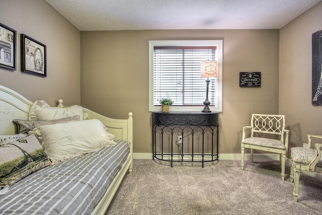 bedroom featuring a textured ceiling, baseboards, and carpet floors