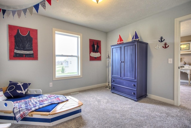 bedroom featuring a textured ceiling, baseboards, and carpet floors