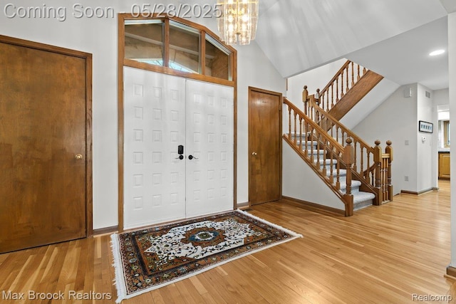4395 Hickory Ct, Orchard Lake, MI 48323 - foyer featuring light wood finished floors, stairs, a chandelier, baseboards, and recessed lighting
