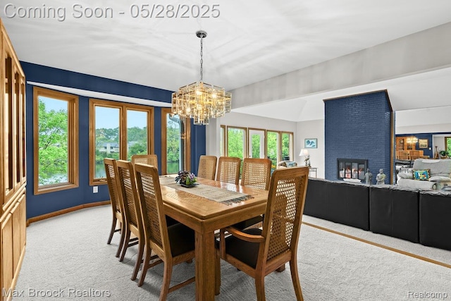 4395 Hickory Ct, Orchard Lake, MI 48323 - dining area featuring light carpet, a chandelier, plenty of natural light, and a brick fireplace