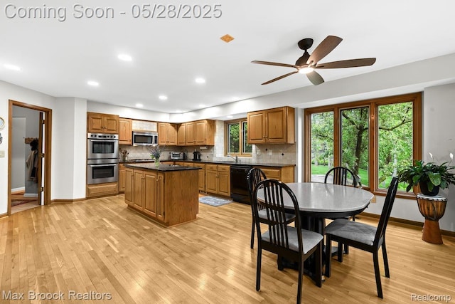 4395 Hickory Ct, Orchard Lake, MI 48323 - kitchen featuring appliances with stainless steel finishes, dark countertops, light wood-style flooring, and recessed lighting