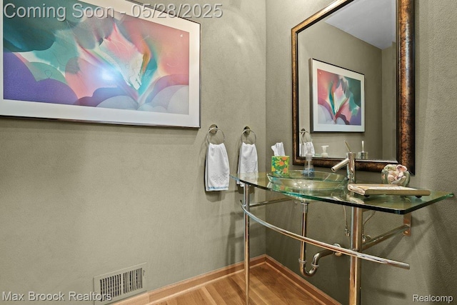 4395 Hickory Ct, Orchard Lake, MI 48323 - bathroom featuring wood finished floors, baseboards, and double vanity