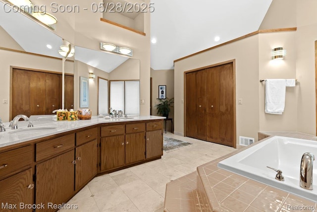 4395 Hickory Ct, Orchard Lake, MI 48323 - full bathroom with vaulted ceiling, double vanity, a bath, and tile patterned floors