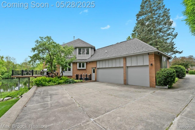 4395 Hickory Ct, Orchard Lake, MI 48323 - view of front of house featuring roof with shingles, brick siding, a garage, and driveway