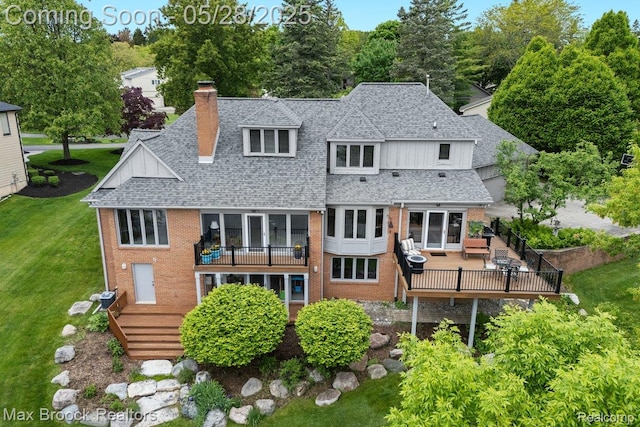 4395 Hickory Ct, Orchard Lake, MI 48323 - back of property with a shingled roof, brick siding, a chimney, and a lawn