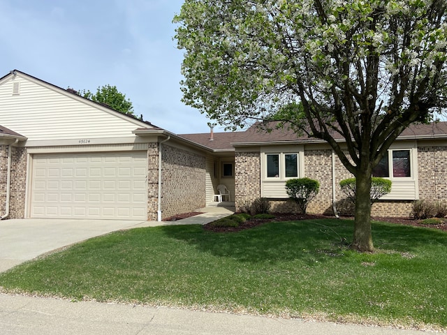 single story home with brick siding, an attached garage, a front lawn, and driveway