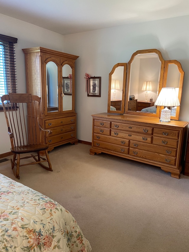 bedroom featuring light carpet and baseboards
