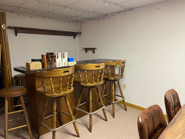 indoor dry bar with carpet and baseboards