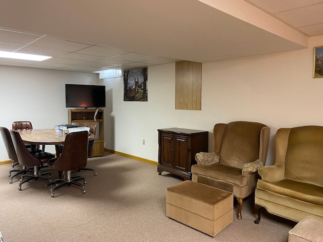 office area with carpet, a drop ceiling, and baseboards