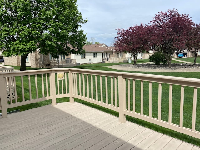 wooden terrace featuring a lawn and a residential view