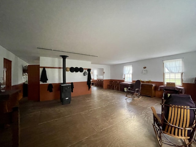 5671 Blair Rd, Reading, MI 49274 - interior space featuring a wood stove and concrete floors