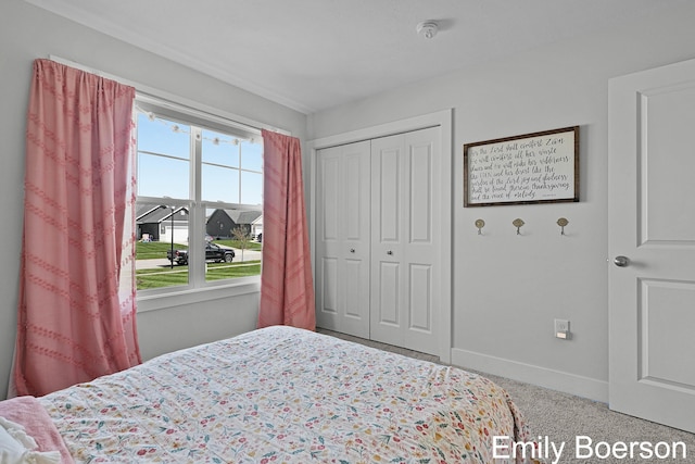 bedroom with baseboards and a closet