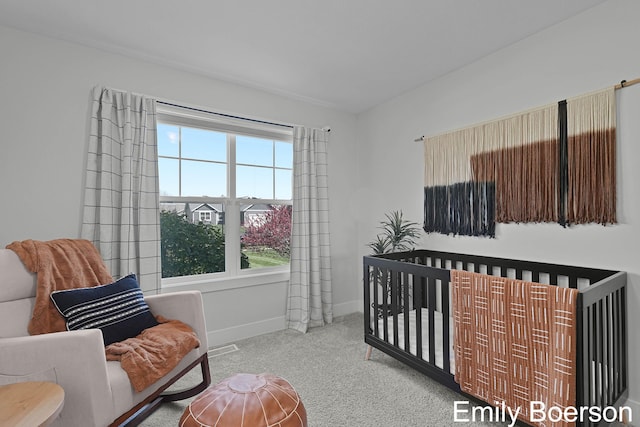 carpeted bedroom featuring visible vents and baseboards