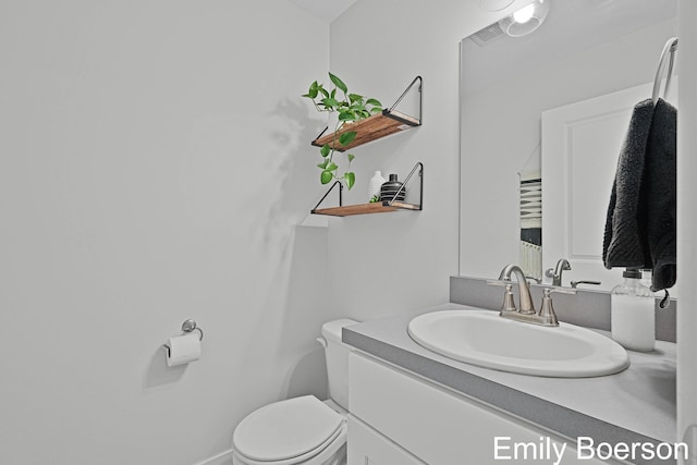 bathroom featuring toilet and vanity