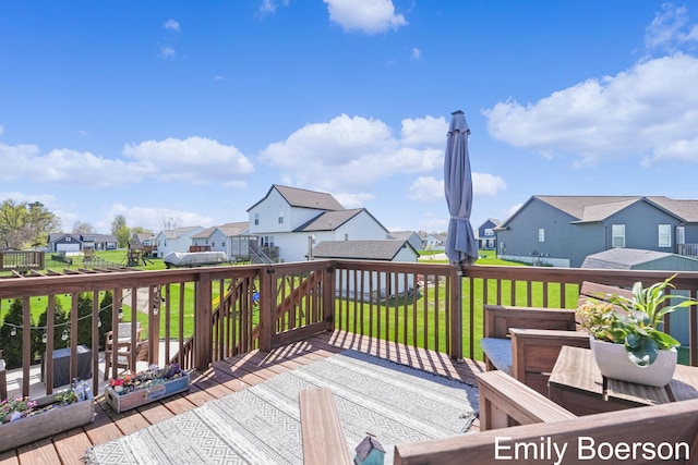 deck with a lawn and a residential view