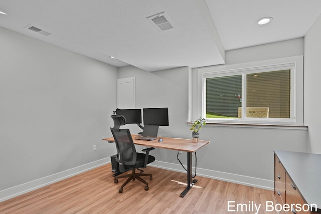 office space featuring baseboards, light wood-type flooring, visible vents, and recessed lighting