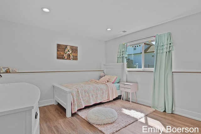bedroom featuring wood finished floors, baseboards, and recessed lighting