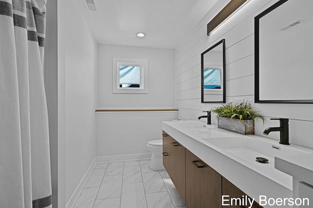 bathroom featuring a sink, toilet, marble finish floor, visible vents, and recessed lighting