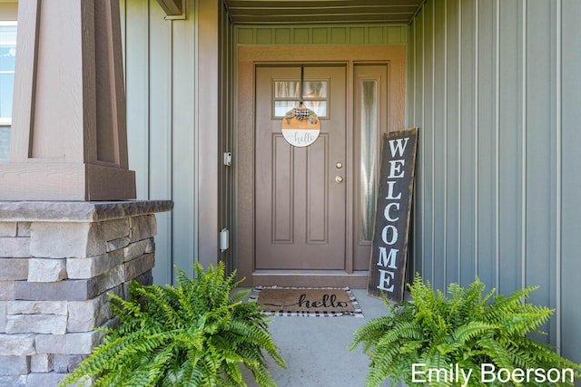 property entrance featuring board and batten siding