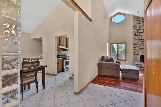 53201 Maranatha Ln, Wixom, MI 48393 - foyer entrance with light tile patterned floors, high vaulted ceiling, and baseboards