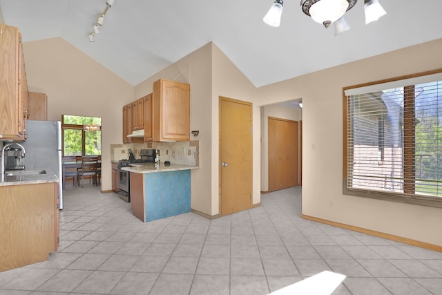 53201 Maranatha Ln, Wixom, MI 48393 - kitchen featuring stainless steel gas stove, tasteful backsplash, high vaulted ceiling, a sink, and light brown cabinetry