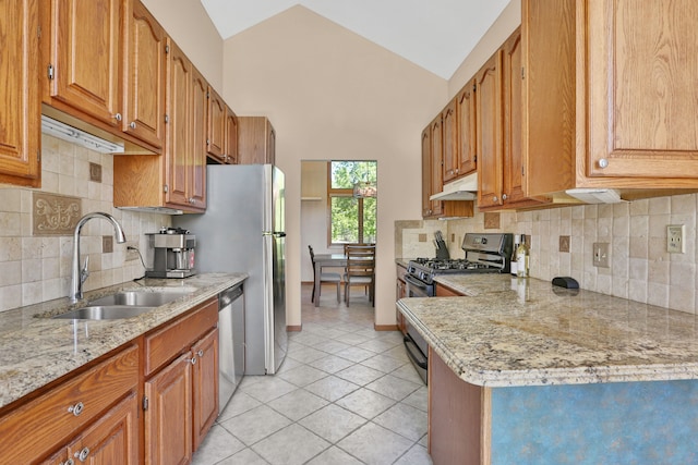 53201 Maranatha Ln, Wixom, MI 48393 - kitchen featuring stainless steel appliances, under cabinet range hood, a sink, light tile patterned flooring, and brown cabinets