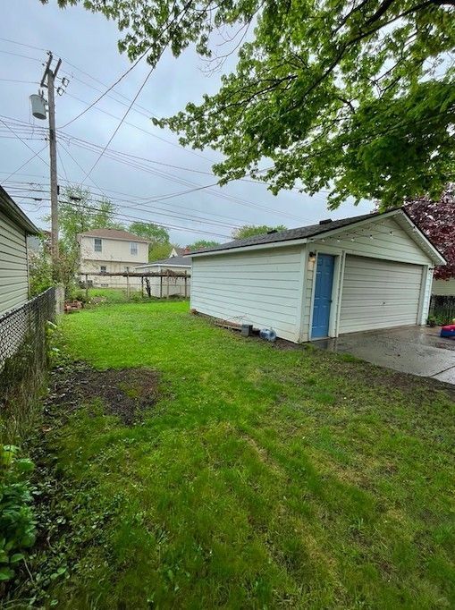 view of yard featuring an outdoor structure and fence