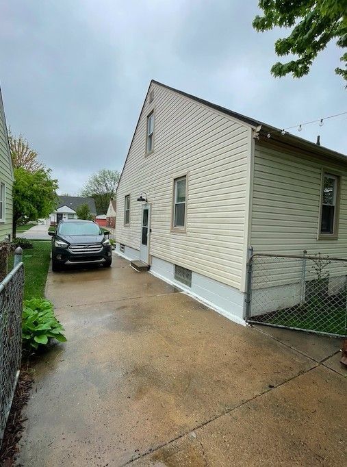 view of property exterior featuring fence