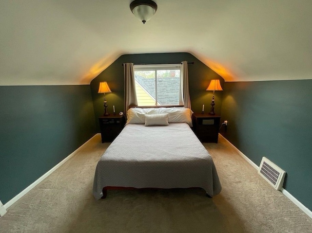 bedroom featuring carpet flooring, visible vents, baseboards, and lofted ceiling