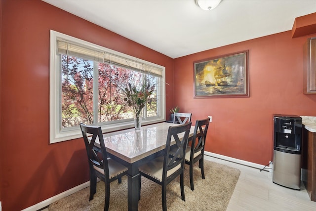 dining area with healthy amount of natural light and baseboards