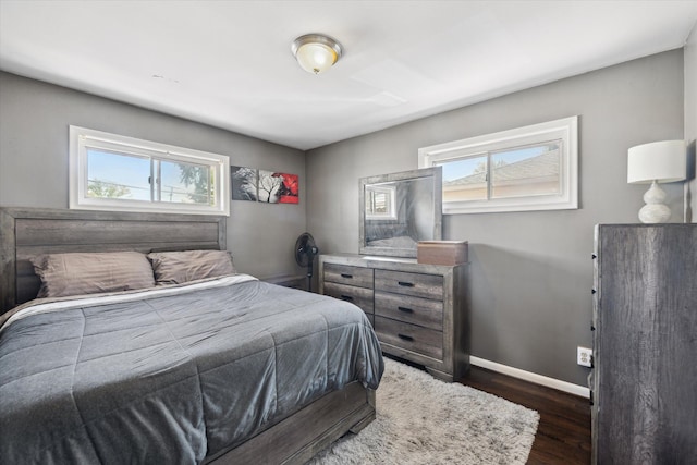 bedroom featuring wood finished floors and baseboards