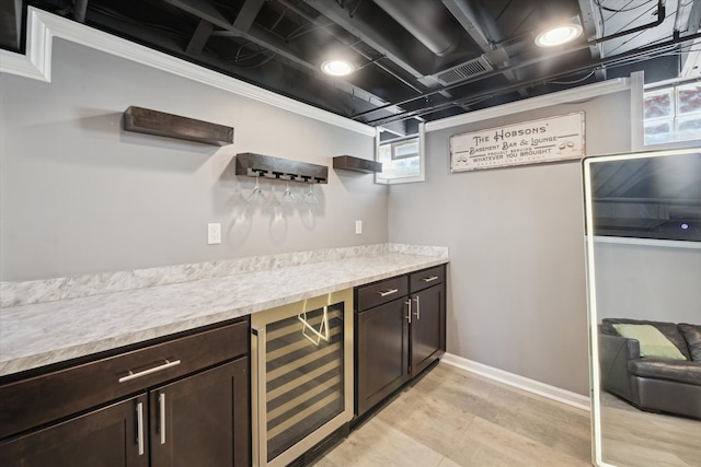 indoor dry bar with beverage cooler and baseboards