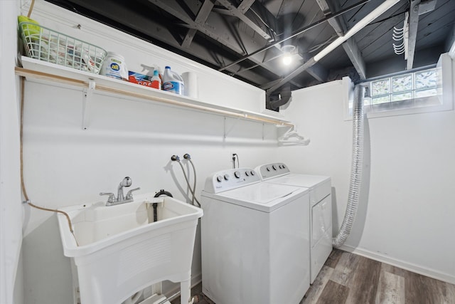 washroom with washing machine and clothes dryer, wood finished floors, and baseboards